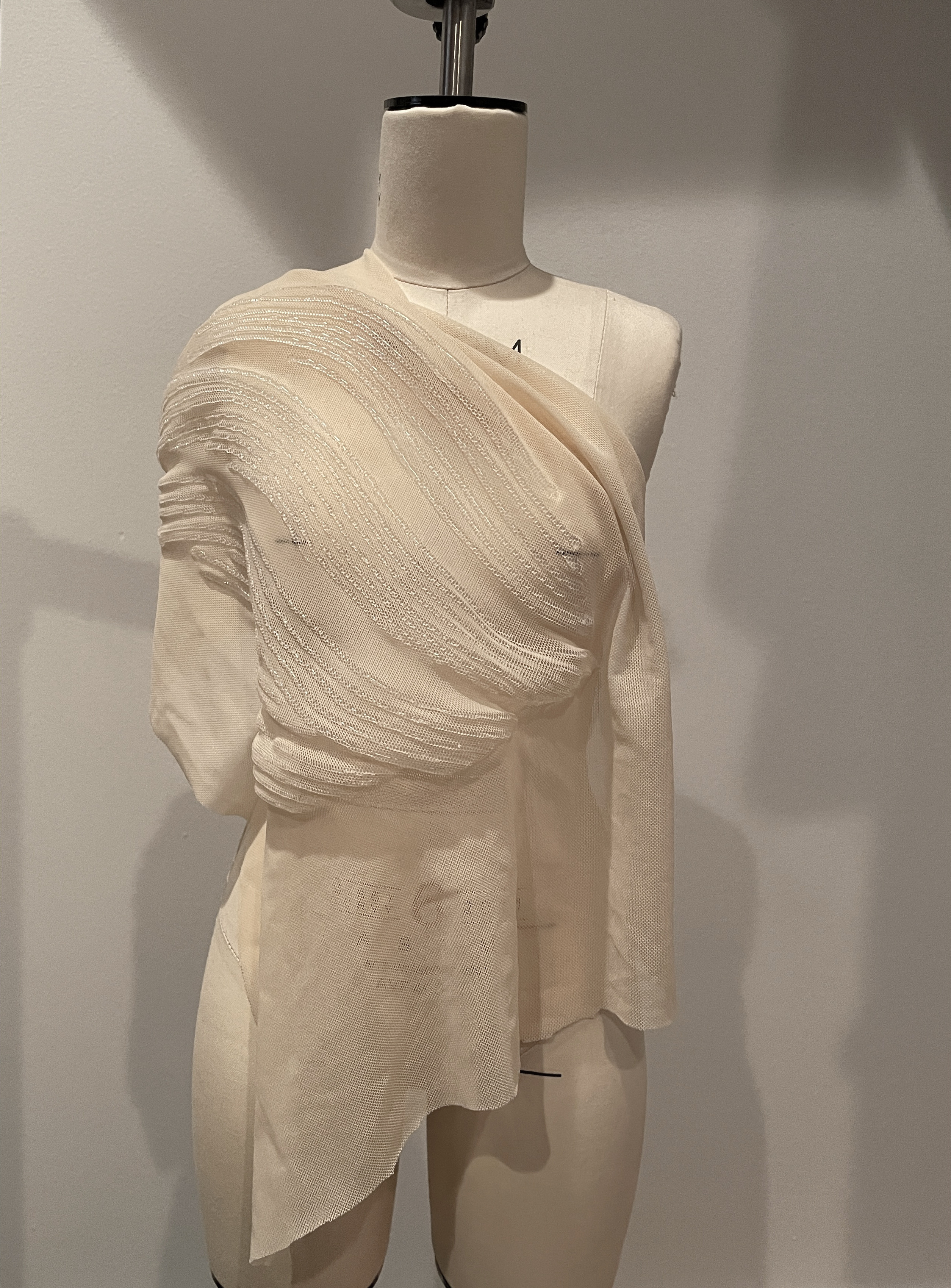 One-shoulder warp texture drape on dress form